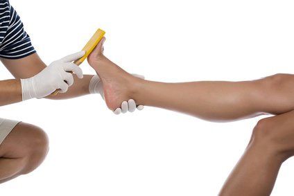 Beautician Scrubbing Female Foot